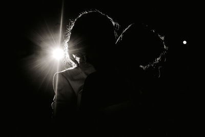 Lesbian couple kissing in dark