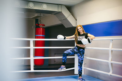 Portrait of young woman standing in ring