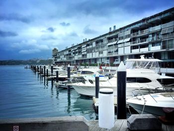 Boats moored at harbor in city