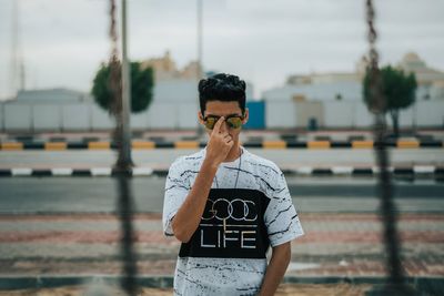 Young man wearing sunglasses standing outdoors