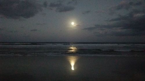 Scenic view of sea against sky at night