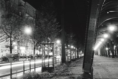 View of illuminated city street during winter at night