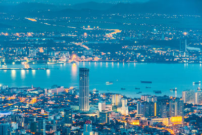 High angle view of illuminated buildings in city at night