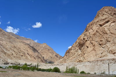 Scenic view of mountains against blue sky