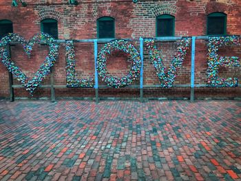 Full frame shot of text on footpath against building