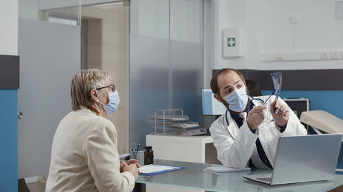 Rear view of female doctor working in laboratory