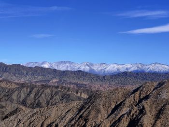 Scenic view of dramatic landscape against blue sky