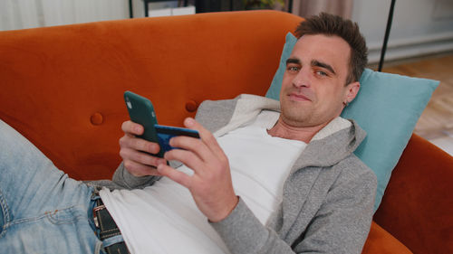 Portrait of man doing online shopping through smart phone