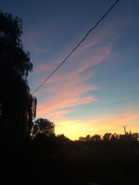 Silhouette of trees against sky at sunset