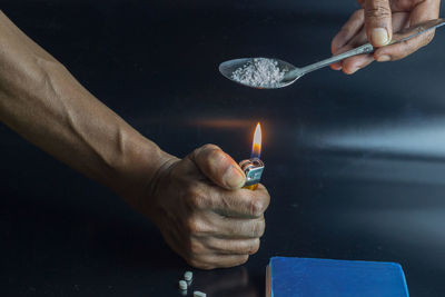 Midsection of person holding cigarette