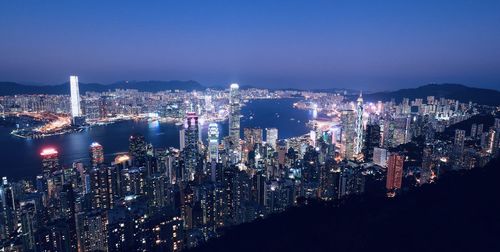 High angle view of illuminated cityscape against sky at night