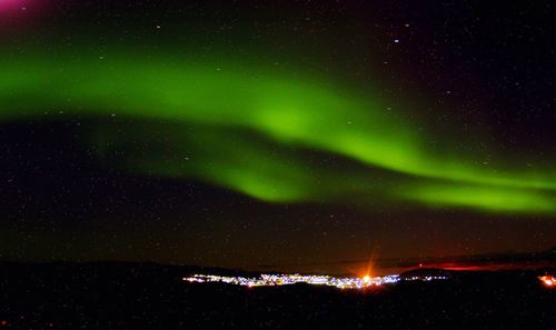 Scenic view of aurora borealis over landscape