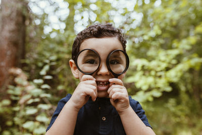 Portrait of man wearing mask against trees