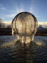 Close-up of water fountain against sky during sunset