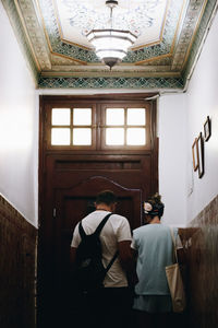 Rear view of woman standing at home