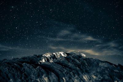 Low angle view of mountain against sky at night