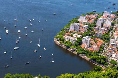 High angle view of sea, boats and houses