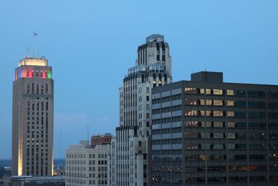 Low angle view of buildings against clear blue sky