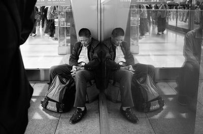 People sitting on seat in shopping mall