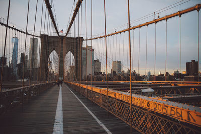 Suspension bridge against cloudy sky