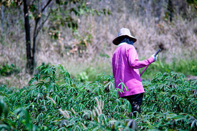 Side view of woman standing on field