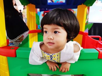 Close-up of cute baby girl on colorful toy