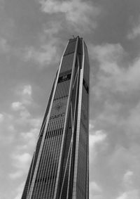 Low angle view of skyscraper against cloudy sky