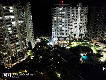 High angle view of illuminated city buildings at night