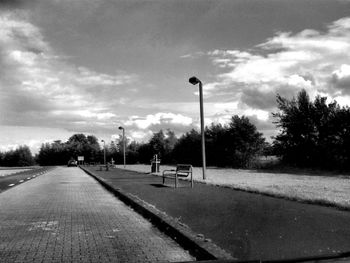 Empty road with trees in background