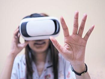 Woman gesturing while using virtual reality simulator