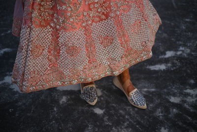 Low section of bride standing on street