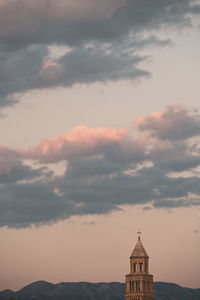 Low angle view of building against cloudy sky