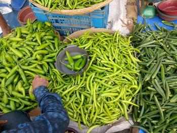 High angle view of man buying vegetables from market stall