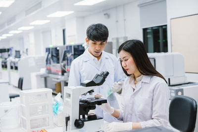 Scientist examining specimen in laboratory