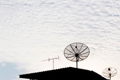 Low angle view of communications tower against sky