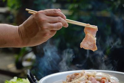 Thailand style bbq grill on a charcoal fire that is located on the bottom with pork, shrimp, squid 