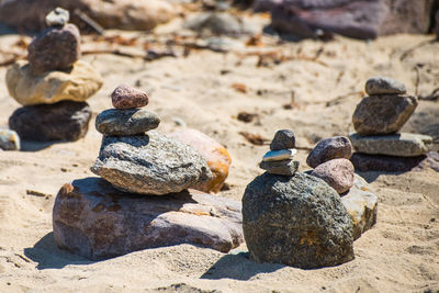 Stack of pebbles on sand at beach
