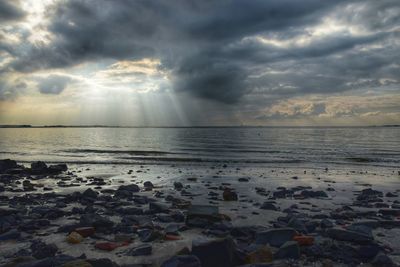 Scenic view of sea against cloudy sky