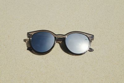 High angle view of sunglasses on sand