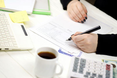 Midsection of businessman working on table