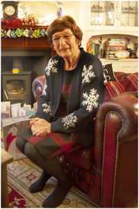 Portrait of smiling woman sitting on chair