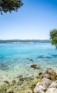 Scenic view of sea against clear blue sky