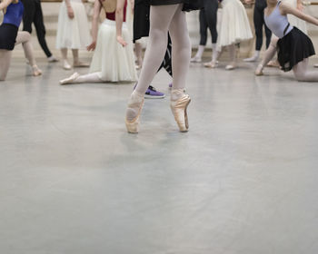 Low section of ballet dancers dancing in studio