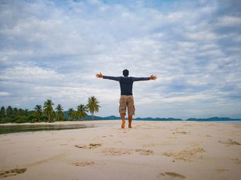 Rear view of man standing on beach