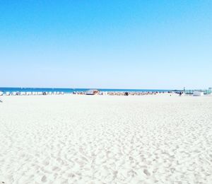 Scenic view of beach against blue sky