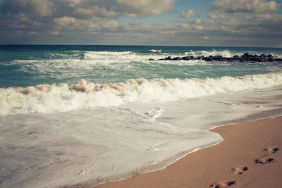 Scenic view of sea against cloudy sky