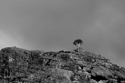 Low angle view of rock formation against sky