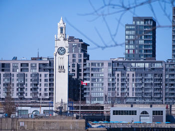 Buildings in city against clear sky