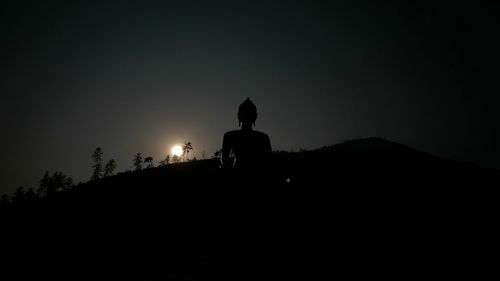 Silhouette of man against sky at night