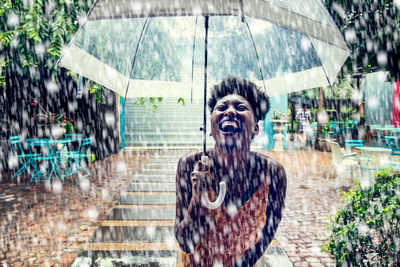 Portrait of woman standing in the rain and laughing